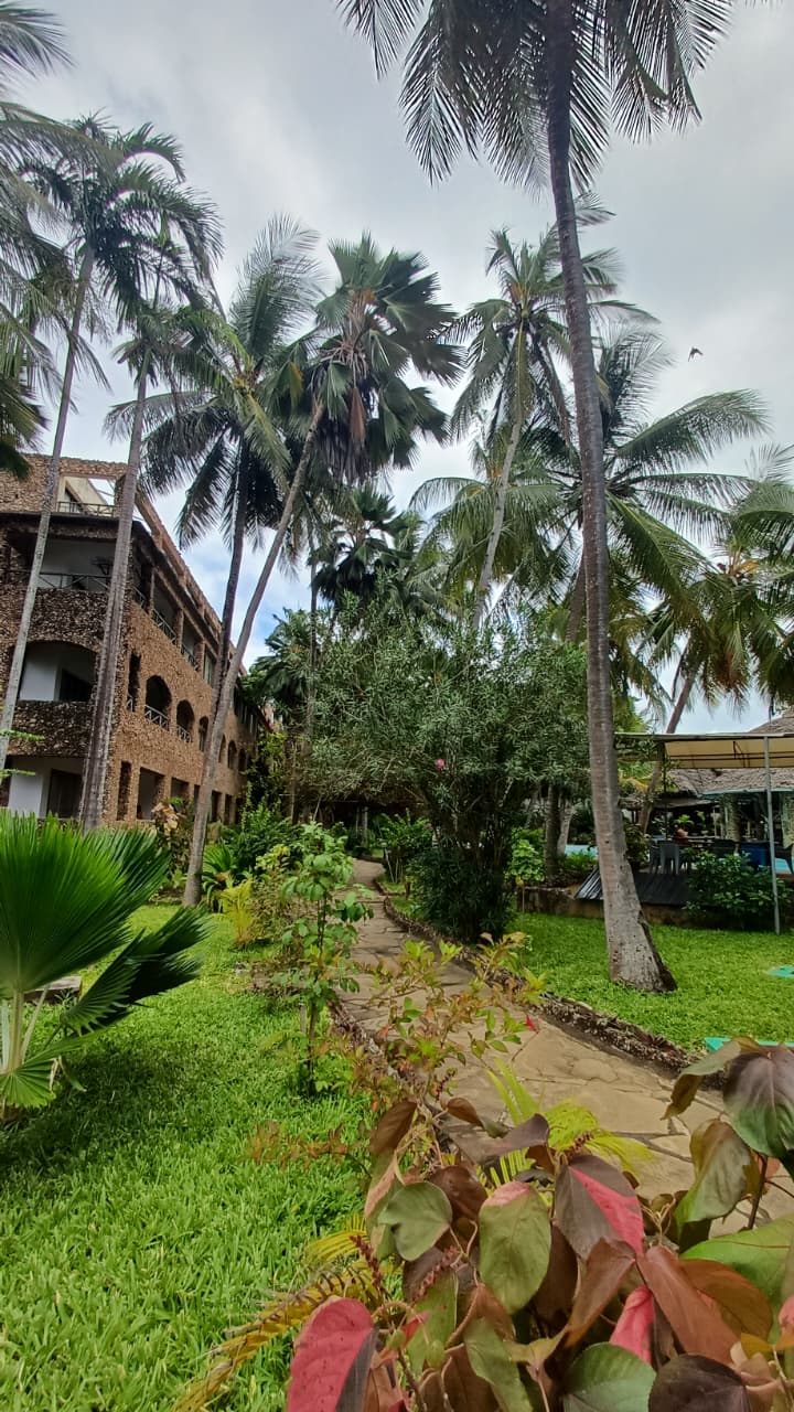 Tropical gardens and coastal architecture at The Paradise Beach Resort